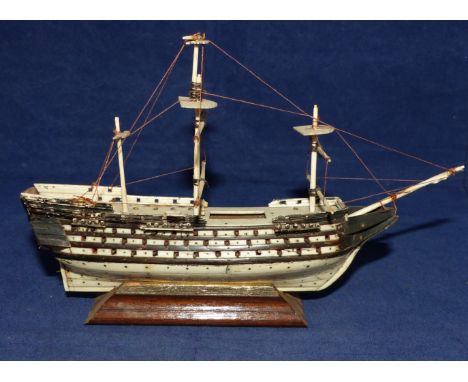 A 19th century prisoner of war work bone model of a battleship of the early 19th century period, length 7½"