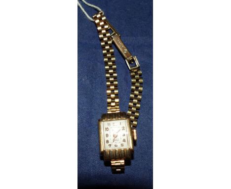 A ladies Majex 9 carat hallmarked gold square wristwatch on 9 carat hallmarked gold gate bracelet