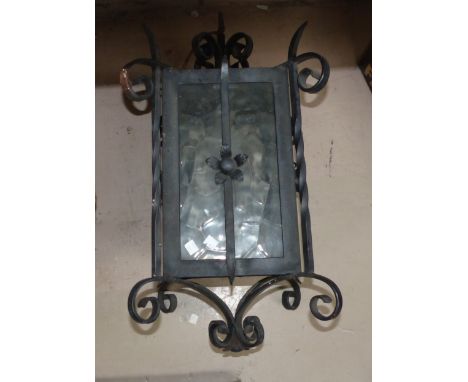 A large black painted wrought iron hall lantern