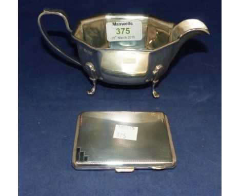 A hallmarked silver octagonal sauce boat, Sheffield; an engine turned silver cigarette case, Birmingham 
