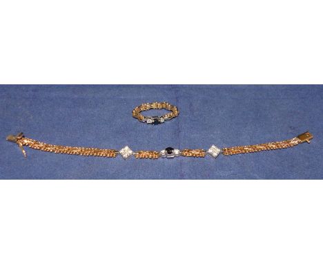 A modern 2 piece bracelet and finger bracelet, of gate bracelet and bead design, each set with a blue sapphire and white sapp