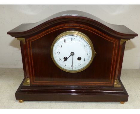 A mahogany mantel clock with enamel dial and inlaid decoration
