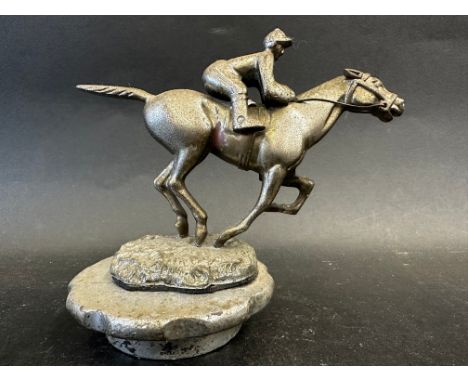 A Desmo car accessory mascot in the form of a horse and jockey, stamped to the base: Copyright, Made in England, mounted on a