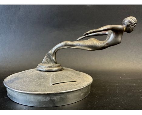 A Desmo car mascot in the form of a diving nude female, display base mounted, approx. 7 1/4" wide. 