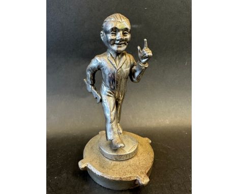 A car mascot in the form of a mechanic in overalls clutching a spanner in his right hand, stamped SPEEDY to the front of the 