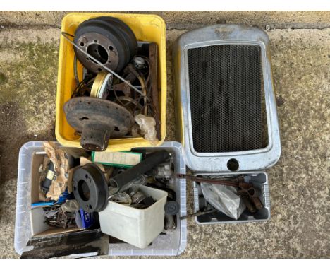 A selection of Austin 7 parts including a chrome radiator shell, with earlier core, brake drums etc.