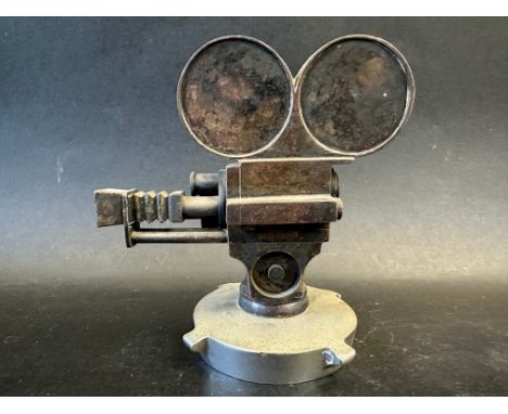 A car mascot in the form of a movie camera, stamped RD NO. 765659, display base mounted, approx. 5 1/4" x 5 1/4". Extremely h