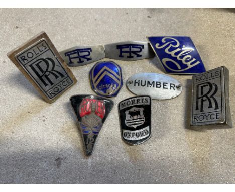 A selection of enamel radiator badges including a good Riley badge, plus an oval enamel plaque bearing a coronet and the numb