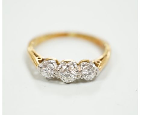 An 18ct, plat and three stone diamond set ring, size K, gross weight 2.7 grams.