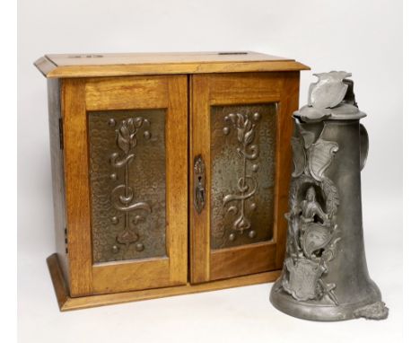 A German pewter commemorative flagon and an Art Nouveau  smoker's cabinet,