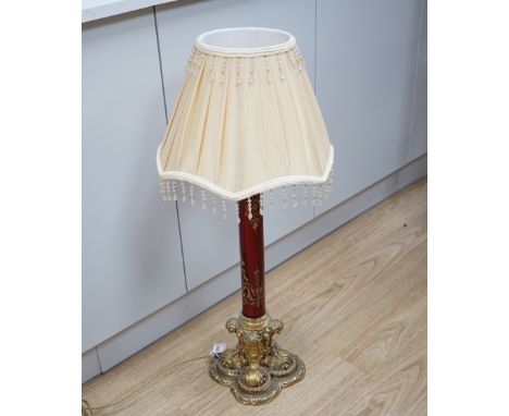 A Victorian style brass and ruby glass table lamp with shade, 81cm