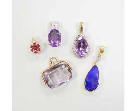 A white metal, stamped PT900, amethyst and diamond cluster set pendant, 18mm, gross weight 5.5 grams and four other pendants 