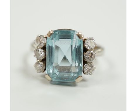 A white metal and single stone emerald cut aquamarine and six stone diamond set dress ring, size P/Q, gross weight 4.2 grams.