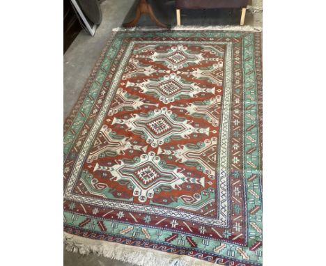 A Caucasian style red ground carpet, 260 x 180cm