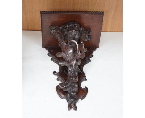A 19th century carved walnut wall bracket, 41cm