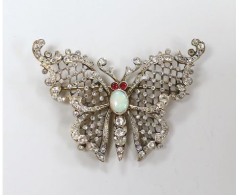 A late 19th/early 20th gilt white metal, white opal and two colour paste set butterfly brooch, width 59mm.