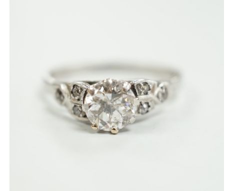 A white metal, stamped plat and single stone diamond ring, with diamond set shoulders, size O, gross weight 3.2 grams, pique 