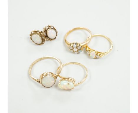 Two 18ct and white opal set rings, one with diamonds, gross 6.2 grams, a 14ct and white opal ring, a 9ct gold and white opal 