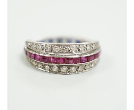 An early to mid 20th century platinum?, ruby, sapphire and diamond set swivelling triple band half eternity ring, size Q, gro