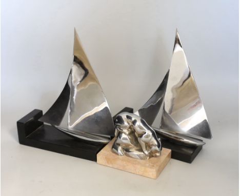 An Art Deco chrome model of a lioness drinking, possibly a car mascot and a pair of chrome yacht bookends, 20cm each wide