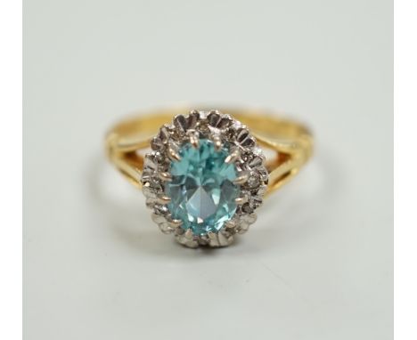 An 18ct, blue zircon and illusion set diamond oval cluster ring, size M, gross weight 5 grams.
