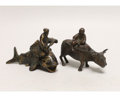 A Chinese parcel gilt metal model of a figure reading a scroll on a fish and one riding a buffalo, tallest 9cm