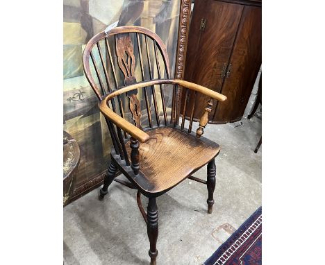 A 19th century Windsor ash and elm comb back elbow chair with crinoline stretcher, width 54cm, depth 40cm, height 94cm