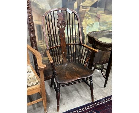 A mid 19th century Windsor elm and beech comb back armchair with pierced central splat, width 58cm, depth 42cm, height 111cm