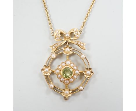 An Edwardian yellow metal, peridot and seed pearl cluster set pendant necklace, overall 55cm, gross weight 5.7 grams.