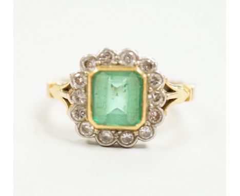 A modern 18ct gold, emerald and diamond set circular cluster ring, size O, gross weight 5 grams.