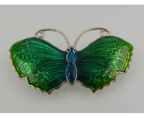 A sterling silver and enamel butterfly brooch, decorated in blue and green enamel. 