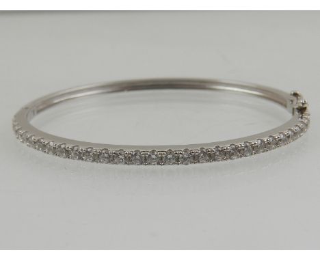 A silver and cubic zirconia set bangle bracelet. 
