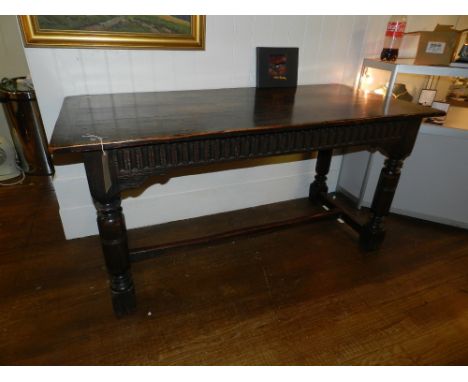 A 19th century oak country table, raised on shaped legs, having bar stretcher. H: 76cm W:153cm D:68cm, together with Victoria