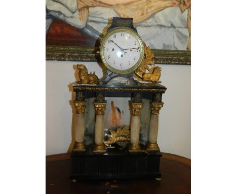 A late 19th century mantle clock, the Roman enamelled dial with outer minute track and subsidiary dial, above four Corinthian