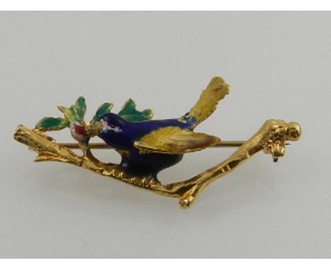 An unusual yellow gold and enamel brooch, in the form of a bird sitting on a holly bough, stamped 750 to reverse. 