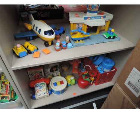 Two shelves of 1970's and later toys including Fisher Price Airport, Chatter Telephone etc