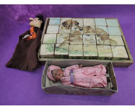 A Heubach Koppelsdorf bisque headed ethnic doll having sleep eyes and open mouth with two teeth showing ,numbered 452-15/0 , 