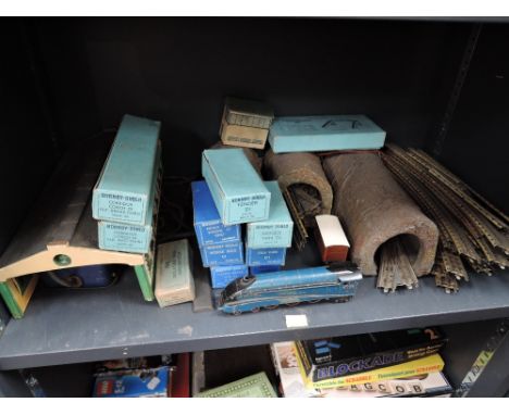 A shelf of Hornby Dublo 00 gauge/three rail including 4-6-2 Sir Nigel Gresley locomotive with boxed tender, six wagons in dar