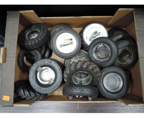 A box of toy car tyre ashtrays, some with ceramic vintage car decoration