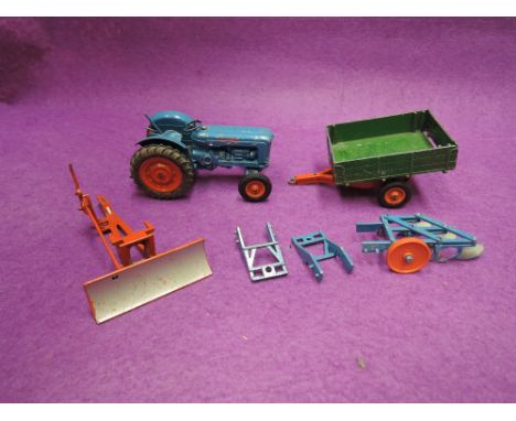 A Britains diecast Fordson Major tractor, trailer, plough, snow plough and two link arm attachments