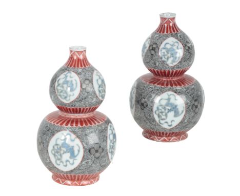 A PAIR OF CHINESE  DOUBLE GOURD VASES late 19th/early 20th century, decorated with panels of bats, amongst profuse scroll dec