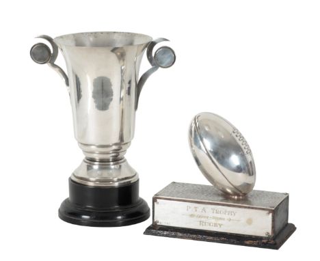 A SILVER PLATED RUGBY TROPHY P.T.A. Inter-House Rugby trophy, modelled as a ball on a rectangular base, 23cm wide; together w