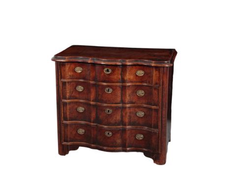 AN EARLY 18TH CENTURY CONTINENTAL WALNUT AND OAK SERPENTINE FRONTED COMMODE with moulded top edge, fitted four drawers enclos