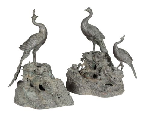 A JAPANESE BRONZE MODEL OF A PEACOCK 19th/20th century, depicting two peacocks perched on a rocky outcrop with foliage, 27cm 