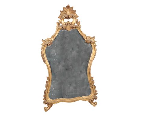 A GEORGE II STYLE GILTWOOD MIRROR 20th century, the cartouche shaped plate within a scrolling and foliate carved surround, 11