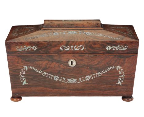 A REGENCY ROSEWOOD AND MOTHER OF PEARL INLAID TEA CADDY of sarcophagus form, the hinged top opening to a partially fitted int