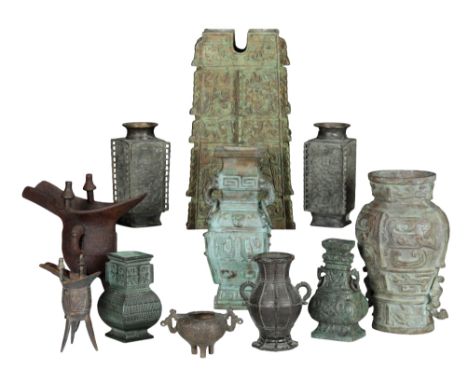 A GROUP OF CHINESE ARCHAIC STYLE VESSELS including a Chinese bronze wine vessel of 'ju' form, on a tripod base, with traces o