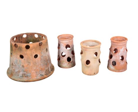 A GROUP OF FOUR TERRACOTTA PLANTERS including three strawberry planter, all with holes to the body, the largest, with no base