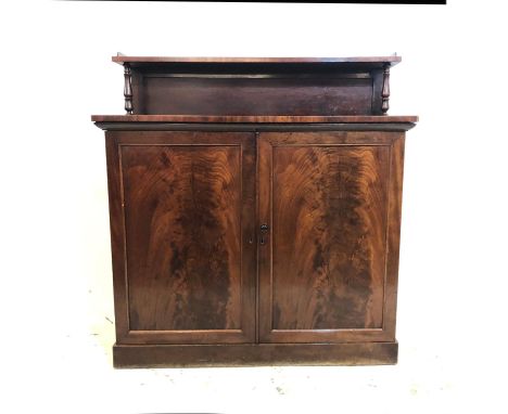 Early C19th Late Georgian Mahogany Chiffonier on plinth base with 2 flame mahogany panelled doors, high waisted with 2 turned