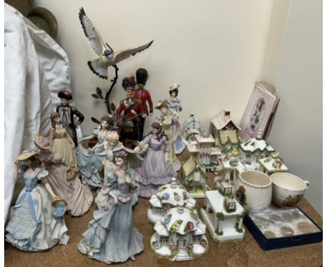 A collection of Coalport cottages together with Wedgwood porcelain figures, Sitzendorf figures, porcelain falcon in flight et